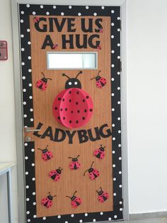 a ladybug door decorated with polka dots and the words give us a hug