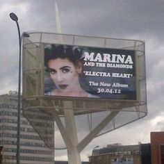 a billboard on the side of a building with an advertisement for marina and the diamonds