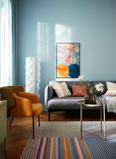 a living room with blue walls and furniture