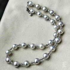 Highlight:  The lustrous silver-gray sheen of these Akoya pearls adds a striking elegance to this classic necklace. Whether at a formal event or a casual gathering, this timeless piece ensures you stand out in any setting. Product Information OriginJapan MaterialAkoya Pearl and 18k White Gold Dimensions-  Pearl Shaped: Close Round Size: 8.5-9 mm Quality: AA+ Nacre: Very Thick Color: White  Luster: Aurora  Accessories Metal: 18k White Gold Other: N/A Gray Pearl Necklace, Grey Pearl Necklace, Classic Necklace, Akoya Pearls, Pearl Grey, Timeless Pieces, Formal Event, Halloween Shopping, Aurora