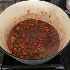 a pot full of food sitting on top of a stove