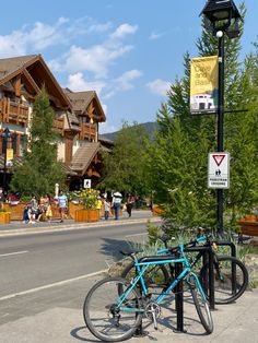 a blue bicycle parked next to a lamp post