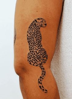 a tattoo on the arm of a man with a cheetah design on it