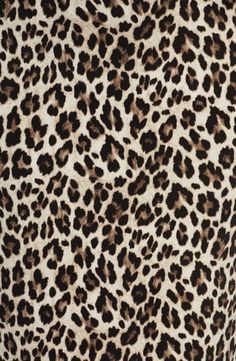 an animal print dress with brown spots on it's chest and neck, as well as