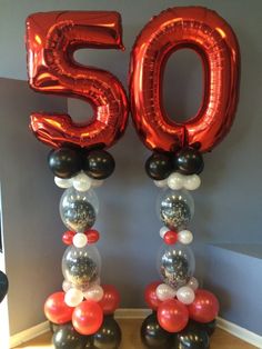 some balloons that are in the shape of numbers 50 and fifty on top of each other