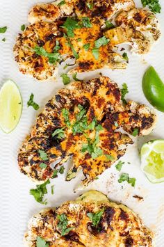 grilled chicken with cilantro and limes on a white plate, ready to be served