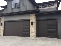 a large house with two garages in front of it