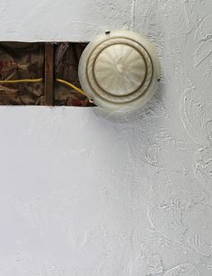 a white light switch on the side of a wall