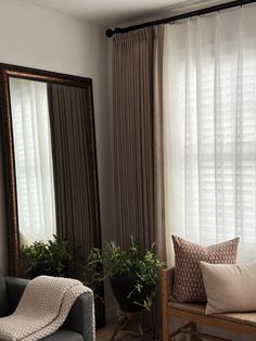 a living room filled with furniture and a large mirror