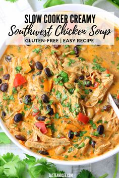 slow cooker creamy southwest chicken soup with black olives and tomatoes in a white bowl