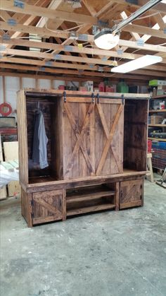 a large wooden cabinet sitting inside of a garage