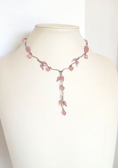 Girlish, romantic, minimal bib necklace, handmade vintage from the '90s. A really charmy, dainty piece of jewelry, light, elegant but eye catching. Silver tone metal garland is combined with light pink glass beads and enamel leefs charms. Short necklace, stands high at the neckline, but continues at a long bib of the same kind. Total length 41.00 with additional expand chain, bib length 8.50 cm. Please remember that it is not a new item, so there can be time signs on it. In perfect condition. Handmade Adjustable Feminine Necklace, Handmade Adjustable Feminine Necklaces, 90s Beaded Necklace, Delicate Pink Choker Necklace, Pink Wire Wrapped Necklace, Minimal Vintage, Valentines Day Presents, Beaded Statement Necklace, Girlfriend Gift