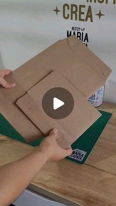 someone is opening up a box on top of a table