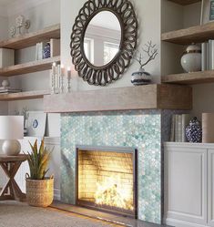 a living room filled with furniture and a fire place under a mirror on the wall