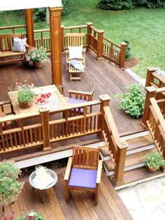 an overhead view of a deck with wooden furniture and potted plants on the side