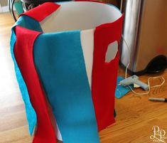 a red, white and blue bag sitting on top of a wooden floor