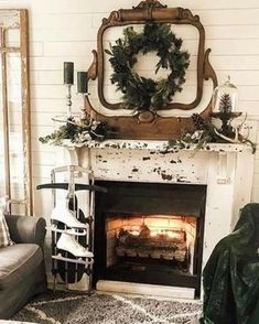 a living room filled with furniture and a fire place covered in a wreath on top of a mantle