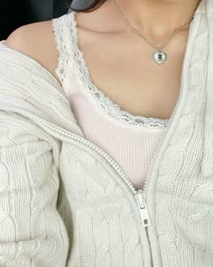 a close up of a person wearing a white sweater