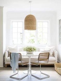 a living room filled with furniture and a white table