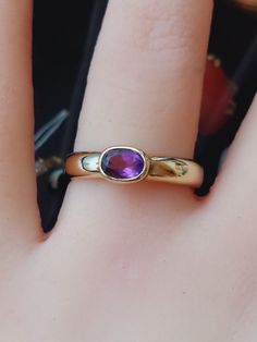 A beautifully made unusual vintage ring featuring an oval cut natural amethyst gemstone. The ring is of lovely quality and is a substantial weight, it is being offered in excellent vintage condition. The ring is fully hallmarked for 9ct yellow gold. Weight 3.6g Approx 0.50 carats amethyst  Ring size O US size 7 Thank you for choosing Carriesclocks! Buying antique and vintage jewellery is both ethical and eco-friendly! Classic Purple Round Band Ring, Classic Oval Purple Birthstone Ring, Classic Amethyst Ring With Bezel Setting For Promise, Classic Amethyst Ring, Classic Oval Amethyst Ring, Classic Amethyst Promise Ring With Bezel Setting, Classic Amethyst Birthstone Ring, Classic Amethyst Round Band Ring, Classic Hallmarked Amethyst Promise Ring