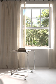 a white table sitting in front of a window