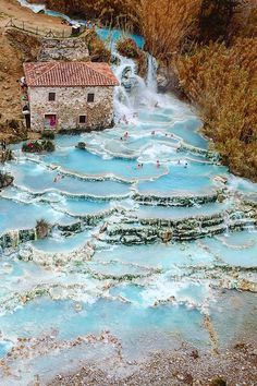 an aerial view of a river running through a village