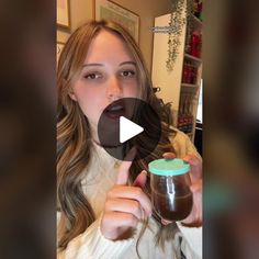 a woman is holding a jar with chocolate in it and making a face while looking at the camera