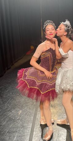 two ballerinas kissing each other on stage