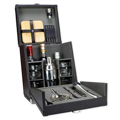 an open black box with various items in it that include knives, spoons and other kitchen utensils