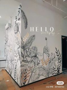 the wall is decorated with black and white flowers, leaves and words that say hello