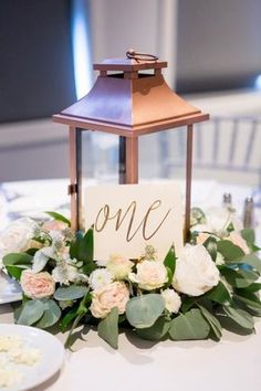 a table with flowers and a sign that says one