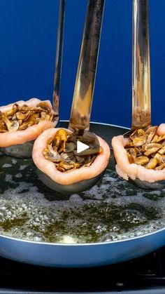 three sausages being cooked in a frying pan