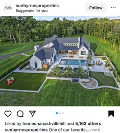 an aerial view of a large house with a pool in the middle and lots of grass