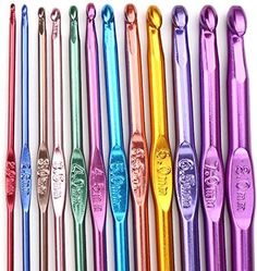 six different colored metal toothbrushes lined up in a row