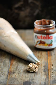 a wooden table with peanut butter and a rolling pin