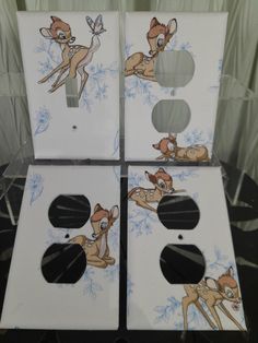 four white boxes with pictures of deers on them