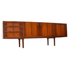 the sideboard is made out of wood and has two doors on each side, one with