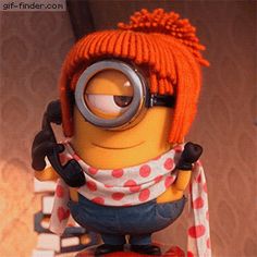 the minion is sitting on top of a table with a scarf around his neck