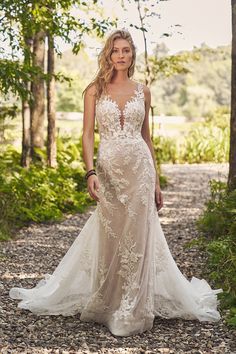 a woman in a wedding dress standing on a path