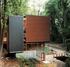 a small house in the woods surrounded by trees