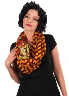 a woman wearing a harry potter scarf with her hands on her hips and looking at the camera