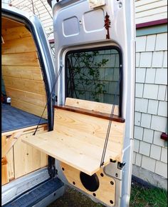 the back end of a van with a table in it