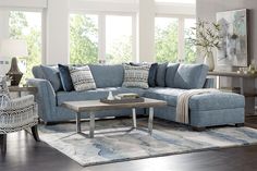 a living room with blue couches and pillows