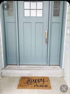 a blue front door with a happy welcome mat