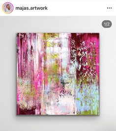 an abstract painting with pink, green and white colors on the wall next to a chair