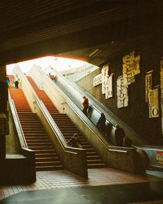 an escalator with people riding down it