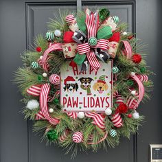 a christmas wreath with dogs and candy canes hanging on the front door to welcome you