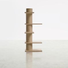 a tall wooden shelf sitting on top of a white floor