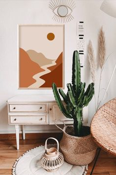 a living room with a cactus in the corner and an art piece on the wall