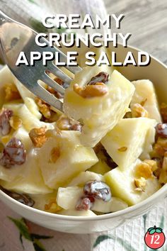 a close up of a bowl of food with a fork in it and the text overlay reads creamy crunchy apple salad